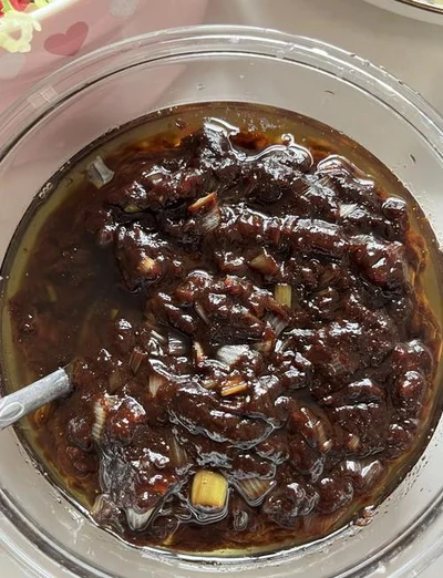 Beijing fermented soybean paste used for Zhajiang Noodles, showing its dark, rich, and aromatic texture after frying.