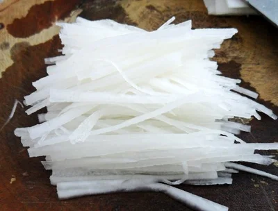 Freshly shredded white radish prepared as a topping for Zhajiang Noodles.