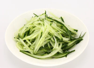 A plate of freshly shredded cucumber used as a topping for Zhajiang Noodles.