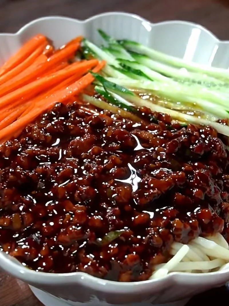 Tianjin-style Zhajiang Noodles with sweet bean paste sauce, shredded cucumbers, and shredded carrots.