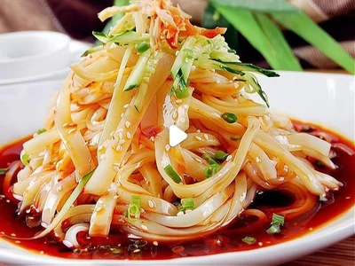 A plate of cold mung bean jelly noodles topped with cucumber, scallions, and chili oil—served as a refreshing starter before Yang Xiezi.