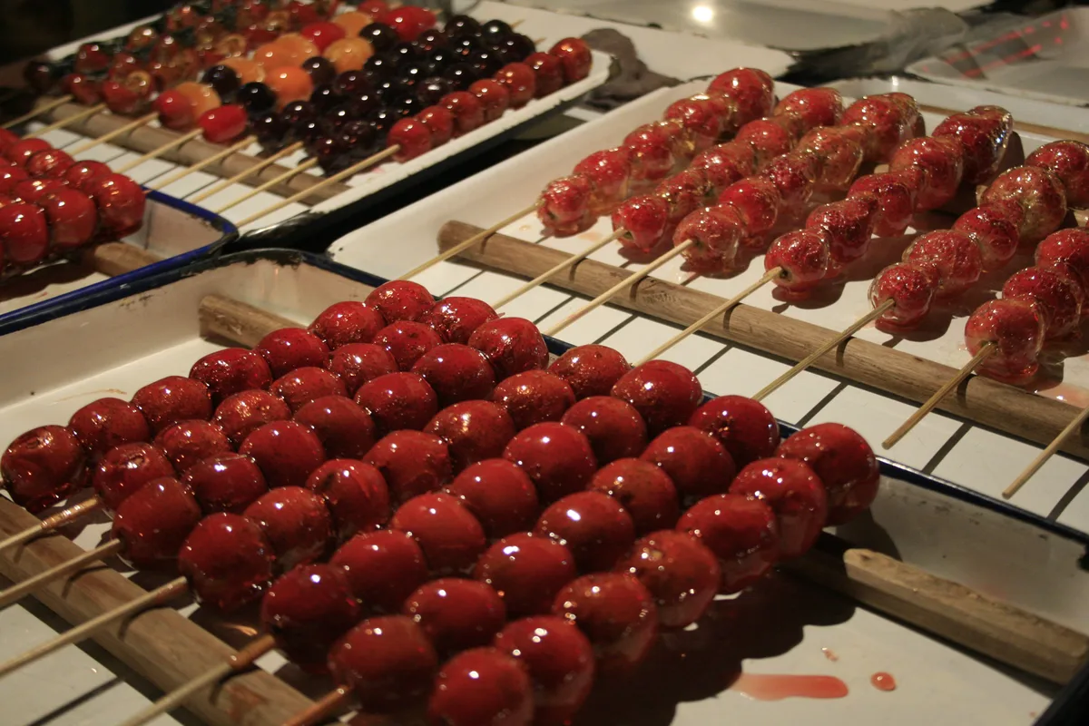 Close-up of glossy candied hawthorn tanghulu skewers