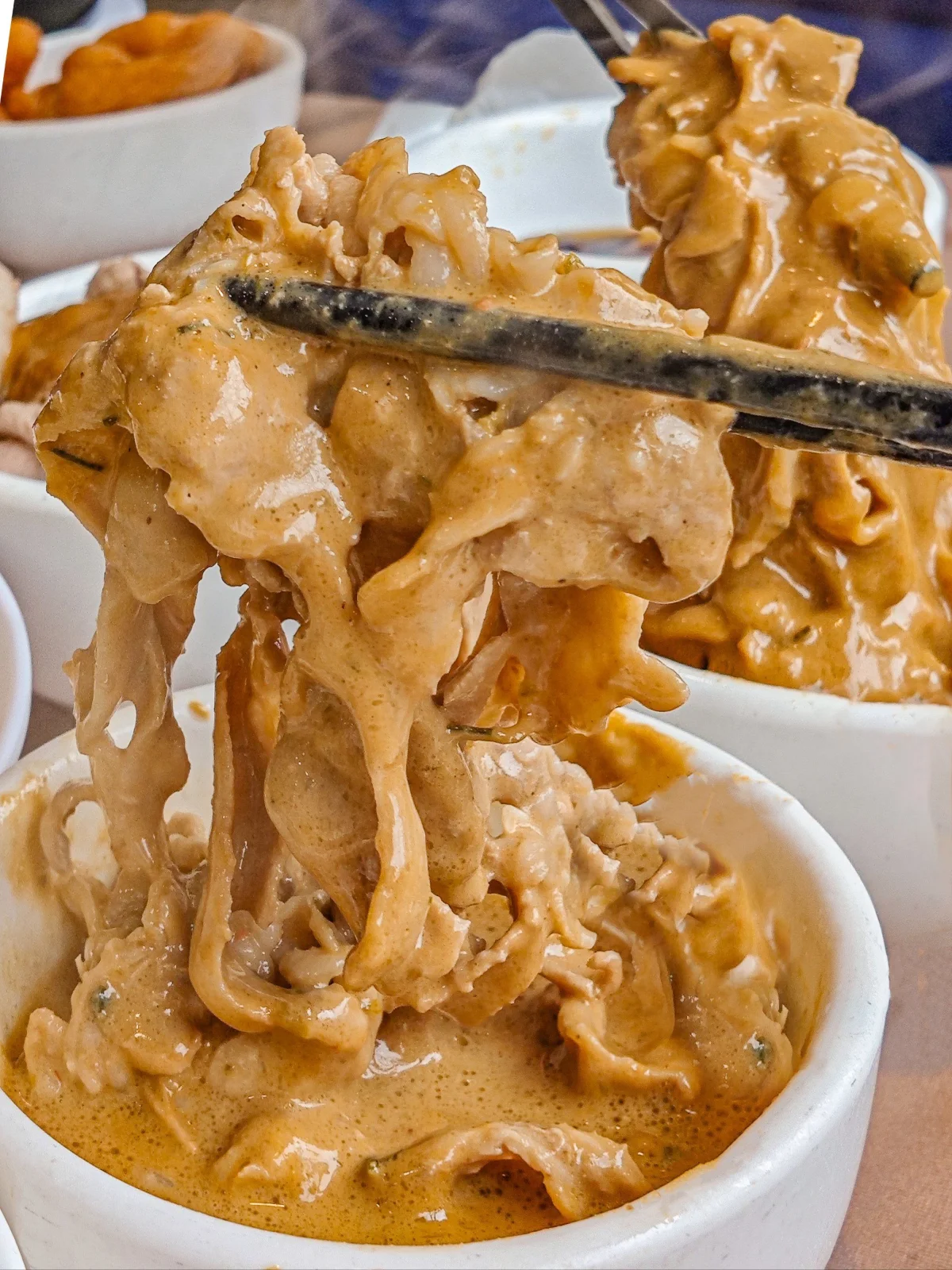 Tripe dipped in rich sesame paste sauce for Beijing hotpot