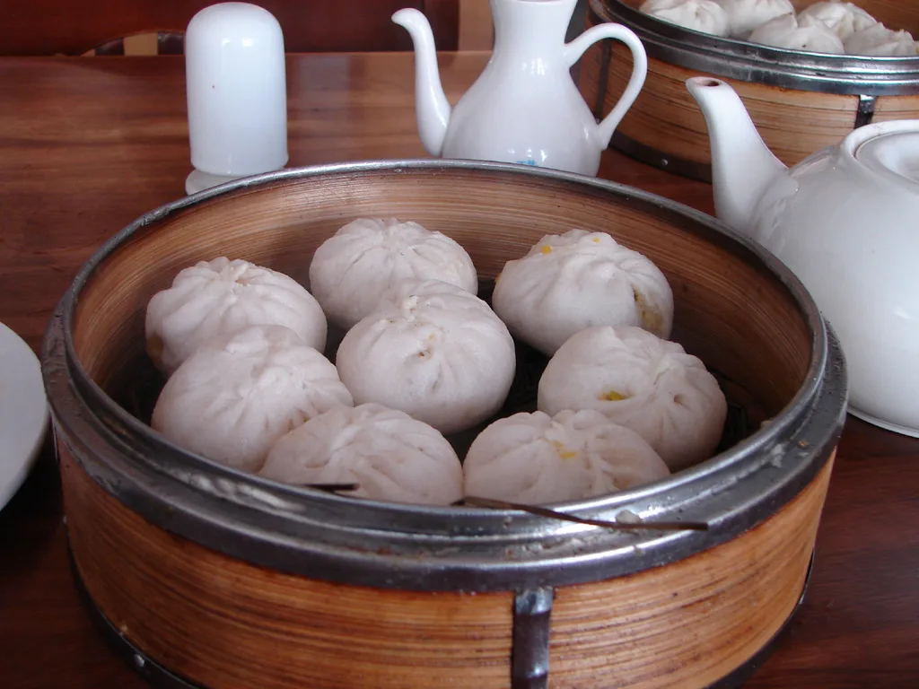 Vegetable-style baozi served in a bamboo steamer basket