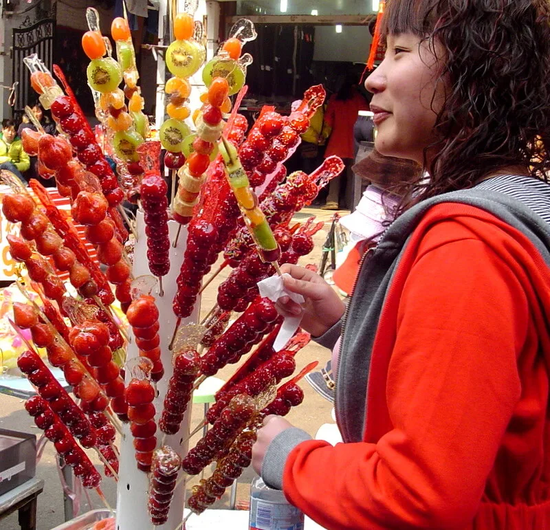 Mixed fruit tanghulu skewers with hawthorn, kiwi, and other fruits on display