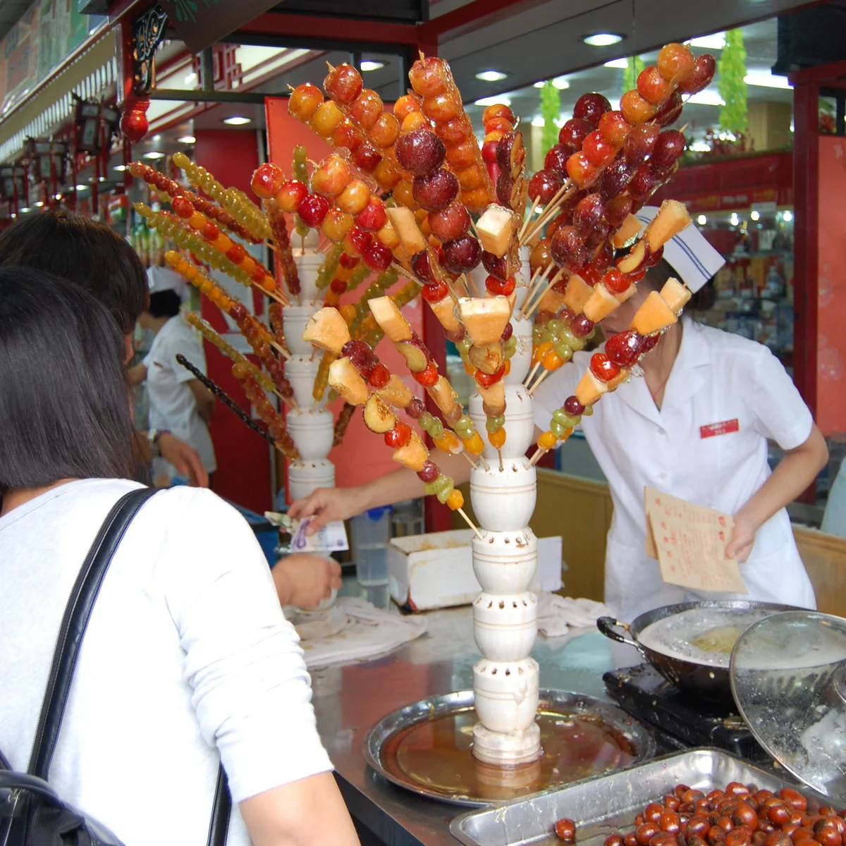 Tanghulu display rack in an old Beijing snack shop with hawthorn and mixed fruit skewers