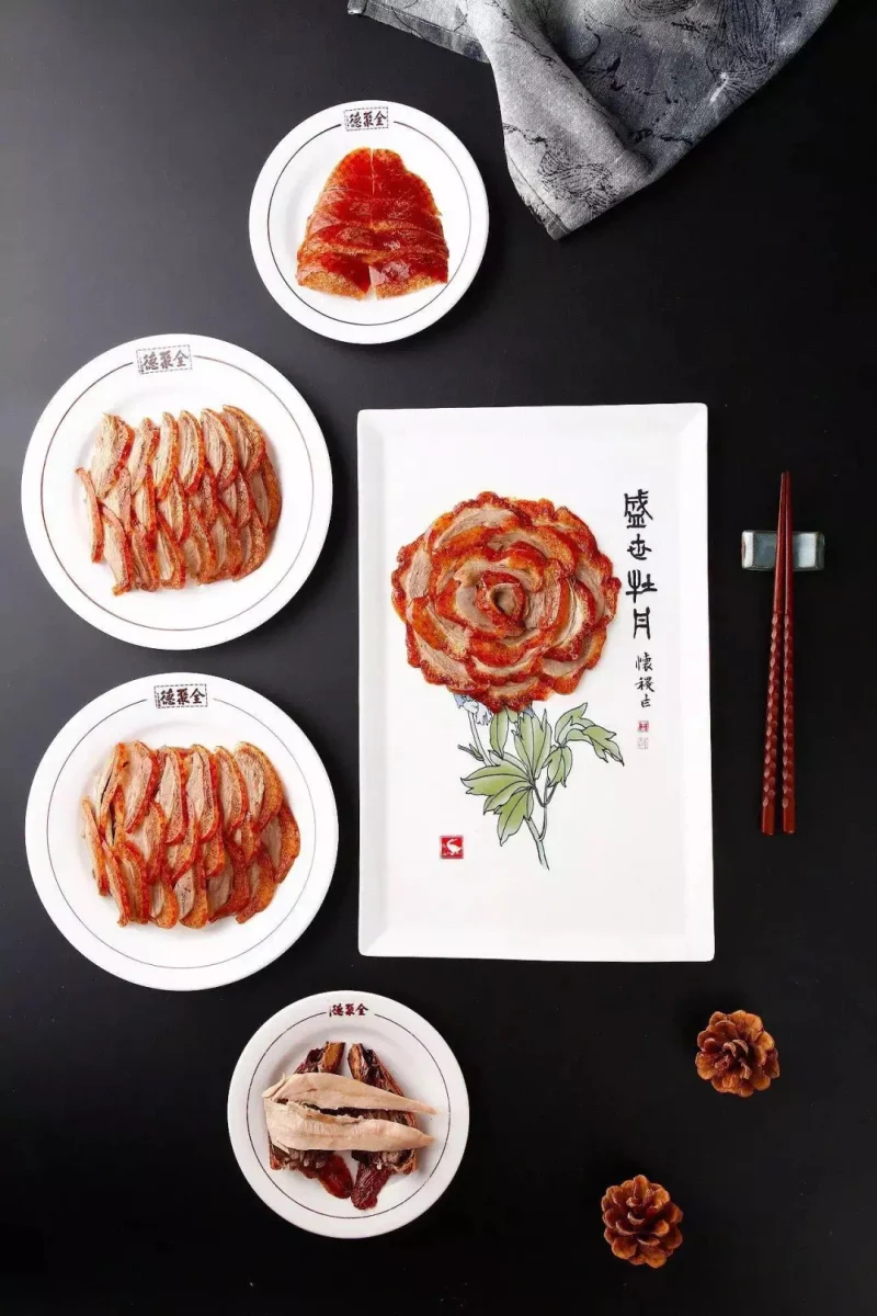 Overhead presentation of Peking duck plates arranged for different skin and meat textures