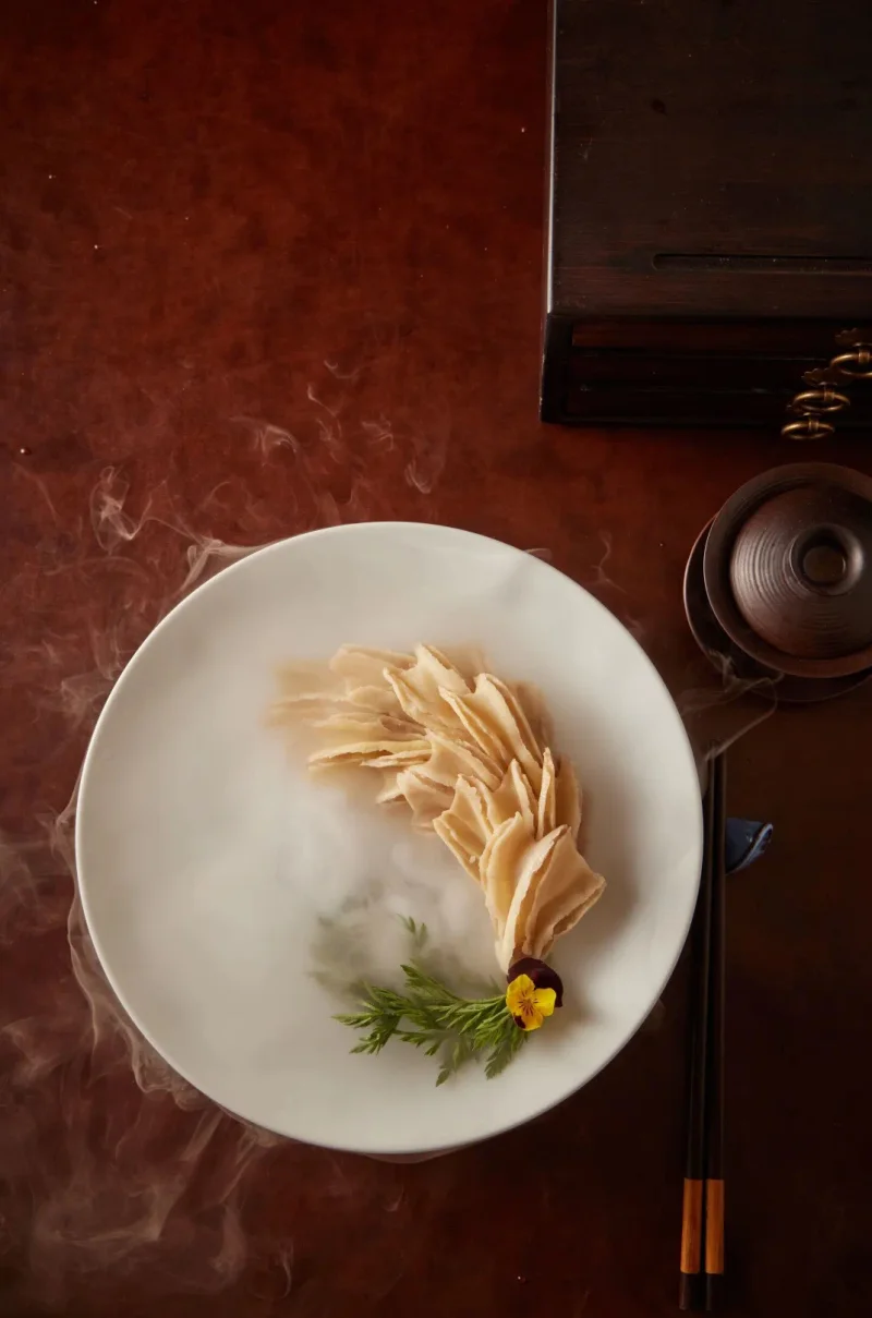 Peking duck skin served separately with sugar for tasting the crisp texture
