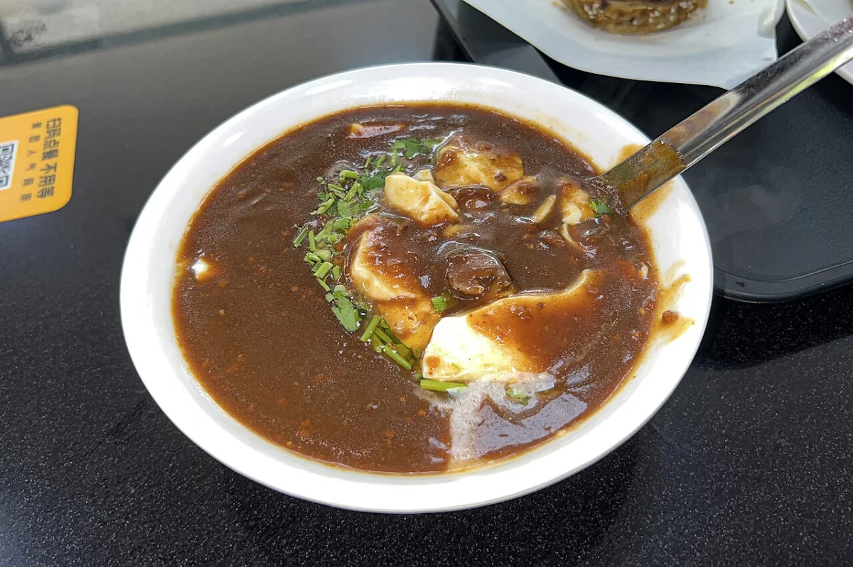 Beijing doufunao served with halal-style beef gravy and cilantro