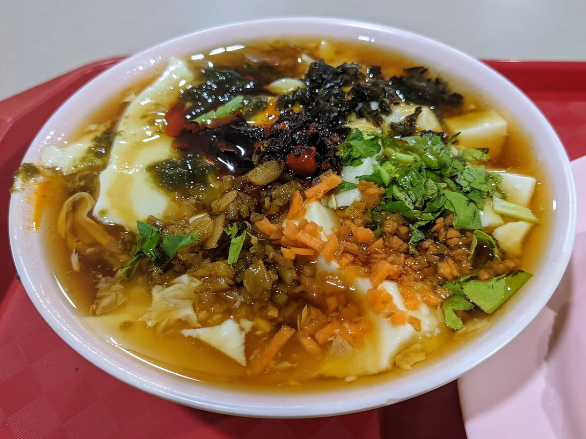 Northern Chinese doufunao with chili, pickled vegetables, cilantro, and soft tofu