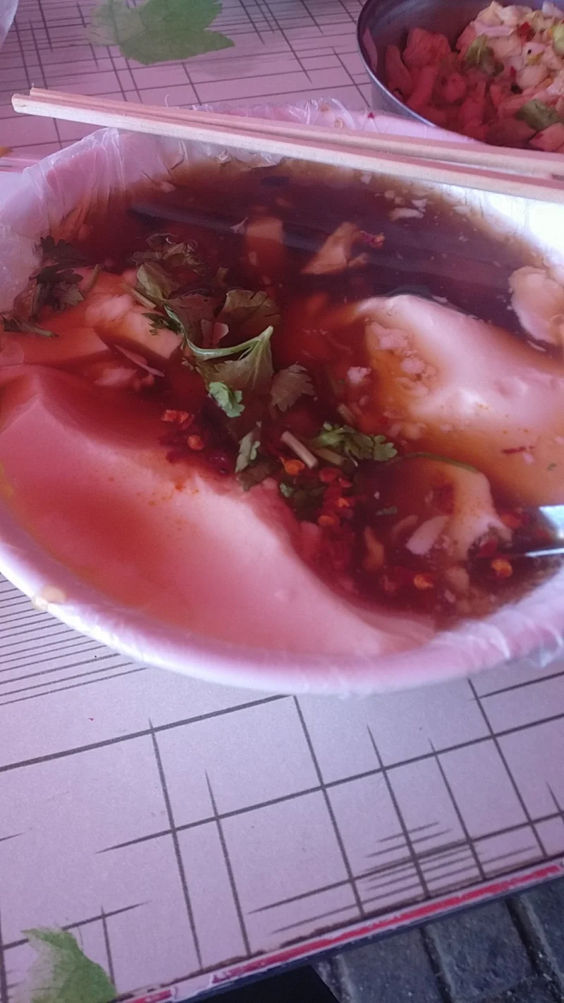 Savory doufunao bowl with gravy, showing the Beijing breakfast style