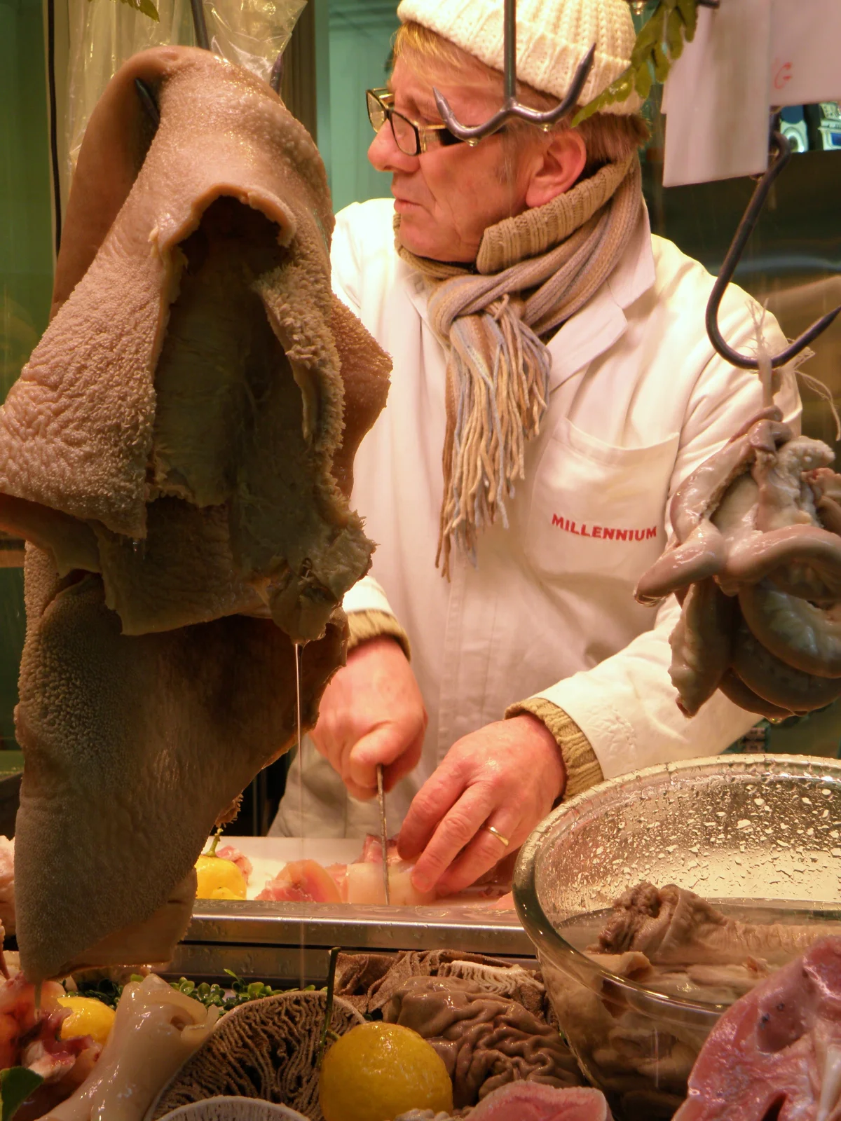 Tripe seller handling stomach cuts before they are prepared for cooking