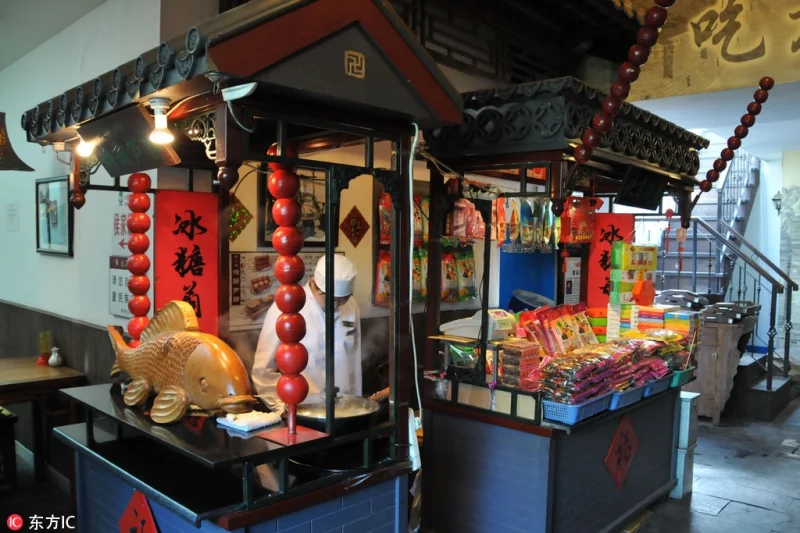 Old Beijing snack stall display showing the food-street setting around traditional snacks