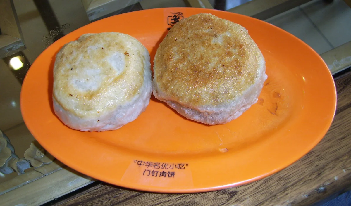 Pair of Beijing men ding rou bing pies showing thick round door-nail shape