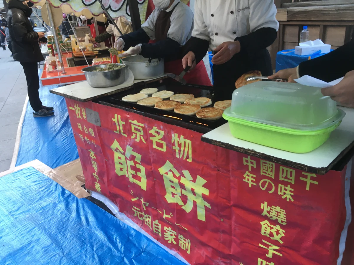 Street stall griddling xianbing-style stuffed pancakes as a comparison to men ding rou bing
