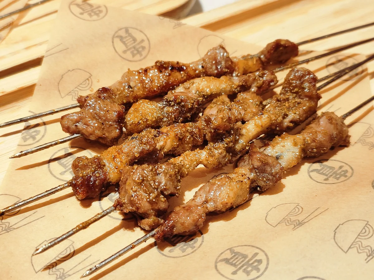 Cooked Chinese chuan sticks arranged on a serving tray