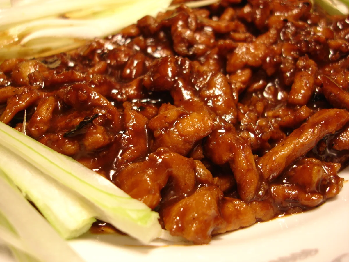 Glossy Jing Jiang Rou Si pork strips served with fresh scallion shreds.