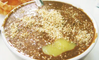 A bowl of dark Beijing miancha with a generous layer of ground sesame