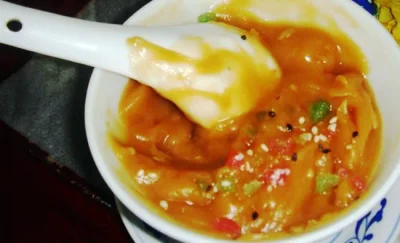A bowl of Beijing youcha, a thick roasted-flour snack with a spoon