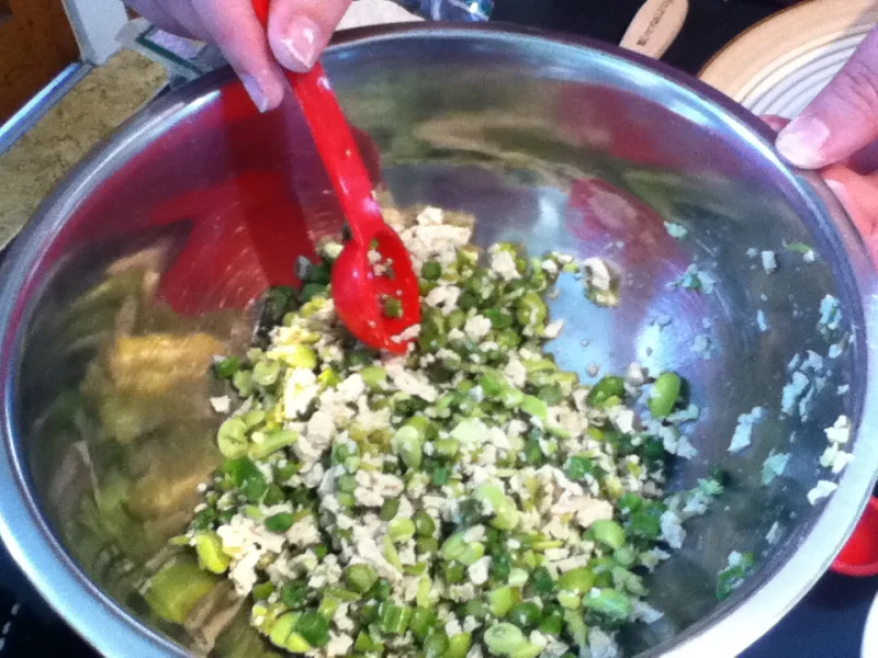 Chopped filling ingredients being mixed before potstickers are wrapped