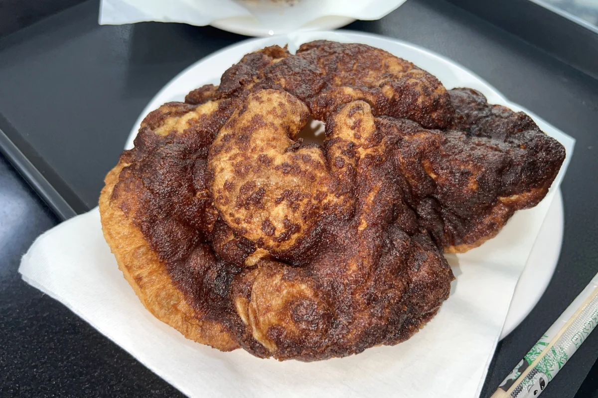 Tangyoubing with a dark brown-sugar surface over the lighter fried dough