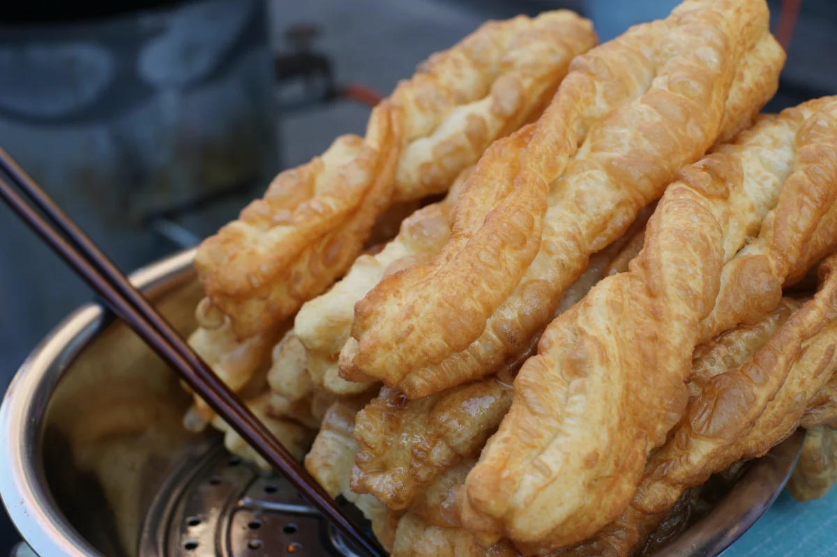 Long golden youtiao showing the joined-strip shape of Chinese fried dough sticks